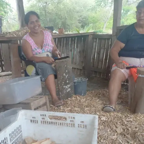 Artisan workers in Ecuador processing Palo Santo wood by hand in a rural workshop
